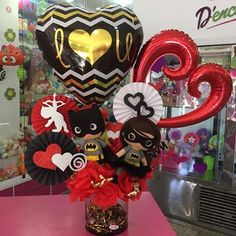 a vase filled with valentine's day decorations and balloons