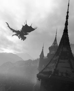 a dragon flying over an old castle in the foggy sky with mountains in the background