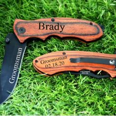 two personalized knifes are laying on the grass with their names engraved on them