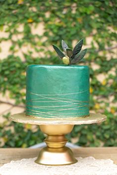 a green wedding cake sitting on top of a table