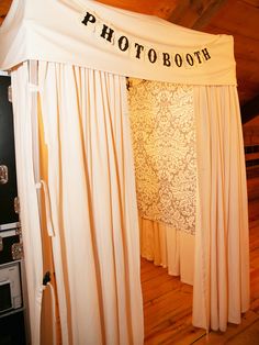 a photo booth set up with white drapes