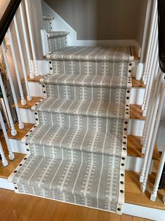 the stairs in this house are decorated with white and gray carpet