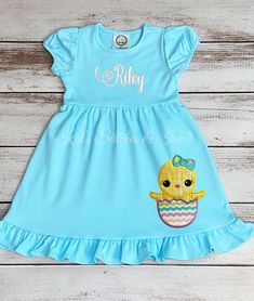 Personalized Girl Chick Easter Day Dress/Toddler Outfit/Ruffle Dress/Girl Easter Dress/Monogram Dress/Applique Easter Dress/Easter Gift This is a personalized Aqua short-sleeve ruffle dress with an easter chick in her egg applique that will go on the bottom lower left side of the dress.  This dress is perfect for your little girl's Easter. All fabrics are adhered to the shirt using a professional-grade heat press machine. PROCESSING TIME IS CURRENTLY 3-5 DAYS FROM THE DATE OF PURCHASE.  Processi Cotton Short Sleeve Twirl Dress With Ruffles, Cotton Twirl Dress With Ruffles And Short Sleeves, Playful Ruffled Dresses For Easter, Fitted Short Sleeve Easter Dresses, Short Sleeve Cotton Birthday Dress, Cotton Short Sleeve Birthday Dress, Short Sleeve Ruffle Dress For Birthday, Fitted Short Sleeve Dresses For Easter, Short Sleeve Ruffled Birthday Dress