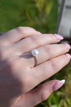 AAA single white button round Pearl Twist Sterling silver ring. This pearl ring is made of 8mm AAA genuine freshwater round pearls, set with sterling silver and crystal mount, size is adjustable, it is an open ring. ~Jewellery: Genuine Pearl Ring, Sterling Silver Ring ~Natural Freshwater pearls ~Pearl Lustre: High, good ~Pearl Shape: button round ~Pearl Colour: white ~Pearl quality: AAA ~Metal: sterling silver with rhinestone, NICKLE FREE, ~Ring size: suitable finger size US5 to US6.5, open ring Diamond White Round Pearl Promise Ring, Diamond White Pearl Promise Ring, Diamond White Sterling Silver Pearl Ring Gift, Adjustable Pearl Drop Ring For Anniversary, White Pearl Drop Ring, Gift Diamond White Pearl Ring In Sterling Silver, Adjustable Pearl Drop Round Rings, Adjustable Pearl Ring For Formal Occasions, Adjustable Formal Pearl Ring