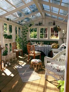 a sun room filled with lots of furniture and plants