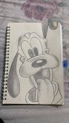 a drawing of mickey mouse on top of a bed