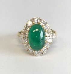 18K Yellow Gold Emerald & Diamond Cocktail Ring Description18K Yellow Gold Ring; 1 Oval Cabochon Cut Emerald 4.00 Carat; 6 Marquis Cut/10 Round Brilliant Cut Diamonds 1.50 Carat Total Weight, Clarity SI-2, Color H-I; Finger Size 6 3/4; 8.6 Grams. Payment All payments must be made through PayPal, NO EXCEPTIONS. We cannot accept payment plans. We do not offer Layaway. Shipping We ship via USPS Registered Mail, Return Receipt in order to provide tracking and insured delivery, which usually takes 5-7 days ($25) **OVERNIGHT SHIPPING available upon request ($40); please request overnight shipping upon your winning bid!! Expedited shipping fee will be added to your total AND expedited shipping service will be arranged for you.  We ship within one business day (holidays and weekends we do not ship Gold Cocktail Ring, Diamond Cocktail Rings, Emerald Diamond, Oval Cabochon, Round Brilliant Cut Diamond, Cocktail Rings, Yellow Gold Rings, Emerald, Gold Color