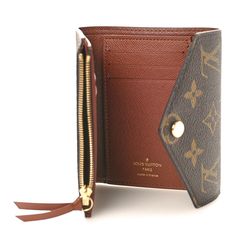 This is an authentic LOUIS VUITTON Monogram Victorine Wallet. This stylish wallet is crafted of traditional Louis Vuitton monogram coated toile canvas in brown. The wallet features an envelope style crossover flap that unsnaps to a brown crossgrain leather interior with card slots, patch pockets, zippered compartment, and billfold. Leather Interior, Authentic Louis Vuitton, Crossover, Louis Vuitton Monogram, Patch Pocket, Card Slots, Slots, Envelope, Louis Vuitton