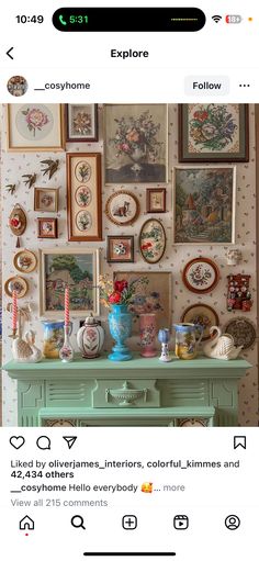 an old dresser with many pictures on the wall above it and below it is a blue vase filled with flowers