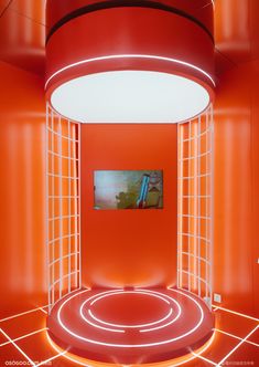 an orange room with red walls and a painting on the wall