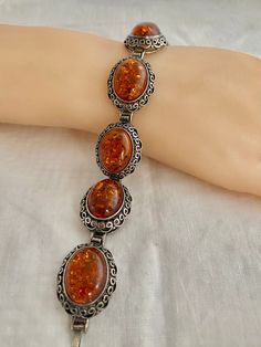 "Poland Amber Cabochons Filagree Vintage Bracelet 43.9 Grams 925 Sterling Silver Hallmark w/ Artist initial 925 Poland Measurements; Bracelet Length - 7.75\" x across 0.89\" Free shipping on all orders over $35.00 however if there is a return, buyer to refund seller for the free shipping cost paid by seller. Visit our shops HauteCoutureLaLa TrendsCouture BorrowedTrends BeautifulPatina LastingTrends" Antique Silver Cabochon Bracelets, Classic Cabochon Bracelets As Gift, Classic Cabochon Bracelets For Gifts, Handmade Oval Sterling Silver Bracelet In Vintage Style, Vintage Sterling Silver Cabochon Bracelets, Vintage Sterling Silver Bracelets With Cabochon, Silver Oval Cabochon Bracelet, Antique Oval Sterling Silver Bracelets, Antique Oval Sterling Silver Bracelet