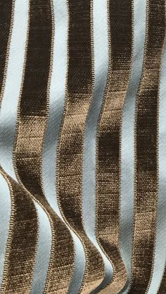 a close up view of a blue and brown striped fabric with vertical stripes on it