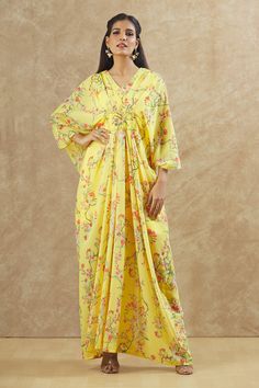 Yellow georgette kaftan with floral print and sequins and beaded hand embroidered placement patchwork. Comes with an inner.
Components: 2
Pattern: Printed, Hand embroidered
Type Of Work: Floral, Sequins, Beads
Neckline: V Neck
Sleeve Type: Kaftan : Flared Sleeves, Inner : Sleeveless
Fabric: Georgette
Color: Yellow
Other Details: 
Front pleats
Occasion: Sangeet - Aza Fashions Floral Print Georgette Kurta With Traditional Drape, Bohemian Georgette Kaftan For Navratri, Spring Georgette Dress With Printed Motifs, Floor-length Georgette Kaftan For Spring, Chikankari Embroidered Georgette Kaftan, Summer Anarkali Georgette Kaftan, Summer Maxi Length Georgette Kurta, Floral Print Georgette Kurta, Yellow Printed Georgette Dresses