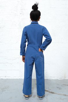 Get ready to enter a bullshit-free zone. This boiler suit is made for movement and comfort, with darts at the back for a feminine touch. Contrast colors at undercollar and sleeve cuff. The style features a wide pant leg and a shorter inseam, so if you’re taller than 5’8”, you get to show off your sexy ankles (or kooky socks or Doc Martens or whatever). 100% cottonMade in China by Uncle Pun Fits true to size. We recommend choosing according to your pant size. If you have a longer torso, please si Blue Overall Jumpsuit For Work, Fitted Blue Jumpsuit With Side Pockets, Blue Denim Jumpsuit With Relaxed Fit And Long Sleeves, Relaxed Fit Long Sleeve Denim Jumpsuit For Work, Long Sleeve Overalls With Side Pockets For Work, Blue Long Sleeve Relaxed Fit Denim Jumpsuit, Fall Blue Jumpsuits And Rompers For Workwear, Blue Long Sleeve Jumpsuit For Work, Blue Workwear Overalls