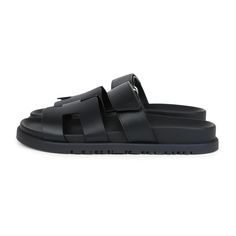 This pair of Chypre Techno sandals are in Black calfskin and feature the iconic H, Black rubber soles, and adjustable straps.Origin: ItalyCondition: New and never wornAccompanied by: Hermes box, dustbags, ribbonSize: 36.5 EU Black Double Strap Sandals With Rubber Sole, Classic Sandals With Tang Buckle In Calf Leather, Luxury Leather Slides With Tang Buckle, Calf Leather Sandals With Tang Buckle And Open Heel, Classic Black Double Strap Sandals, Black Calf Leather Slingback Sandals With Removable Insole, Black Leather Slingback Sandals With Leather Footbed, Luxury Leather Footbed Sandals With Tang Buckle, Black Leather Slingback Sandals With Leather Lining