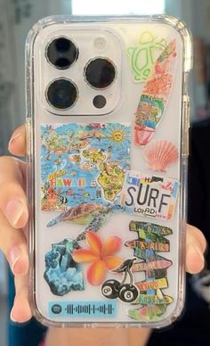 someone is holding up their phone case with stickers on it