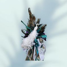 a white and blue feather headdress with feathers attached to it's side