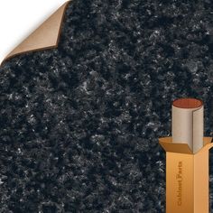 an image of a black granite surface with gold trimmings and a cardboard box