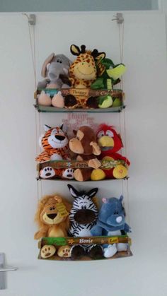 three shelves with stuffed animals hanging from the top and bottom, one on each shelf