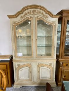 an antique china cabinet with glass doors