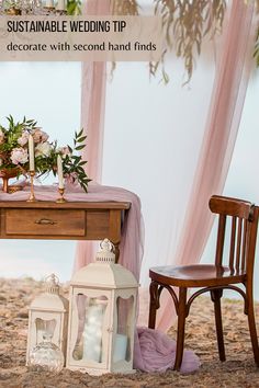 the table is set up with candles and flowers on it, along with two chairs