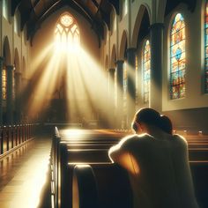 a woman sitting in the pews of a church with sunlight streaming through the stained glass windows