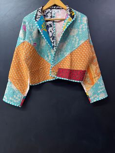 a colorful jacket hanging on a wooden hanger