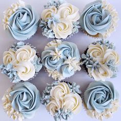 twelve cupcakes with blue and white frosting flowers on them are arranged in a circle