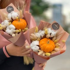 two women are holding bouquets with cotton and pumpkins