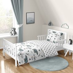 a child's bedroom with a white bed, blue rug and teddy bear toys