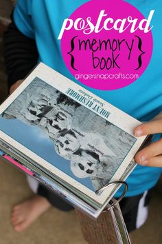 a person holding a book with the title postcard memory book