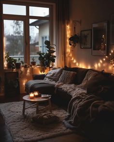 a living room filled with lots of lights next to a couch and coffee table in front of a window