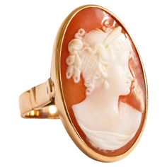 A vintage 14 K Yellow Gold ring with Cameo in an oval setting. The cameo features a female silhouette in the Victorian style. The ring is stamped with K14 that stands for the 14 karat gold content. The item was manufactured in the middle of the 20th century and it is in good vintage condition. The ring size is 6.5. The Cameo ring is one of the most classic example of jewelry that is indispensable in each woman's collection. Cameo Rings Vintage, Female Silhouette, Oval Setting, Cameo Ring, Carved Shell, Woman Silhouette, Yellow Gold Ring, Victorian Style, Victorian Fashion