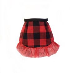 a red and black checkered skirt with ruffles on the bottom, against a white background