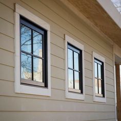 three windows on the side of a house