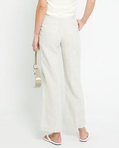 Product Details Introducing the Everyday Linen Pant. Crafted from 100% lightweight linen, this pant offers relaxed, breezy comfort for any occasion. Subtle pleats add shape and style to the effortless design. - Front button- Front zipper- Pockets- Content: 100% Organic Linen Style# C22WPA70018 Fit Notes - Model wearing a size 2- Model measurements: 5'10.5'' Height / 32'' Bust / 25'' Waist / 35'' Hips- Garment measurements: Size Length Waist Hips 0 102,24 68,58 93.98 2 103.19 71.12 96.52 4 104.14 Chic Linen Bottoms For Day Out, Spring Linen Bottoms For Day Out, Relaxed Fit Linen Wide Leg Pants For Day Out, Summer Workwear Pants In Flax Color, Spring Linen Pants For Day Out, Linen Pants For Spring Day Out, Chic Linen Pants For Spring, Summer Workwear Pants In Flax, Chic Neutral Linen Bottoms