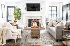 a living room filled with furniture and a flat screen tv mounted above the fire place