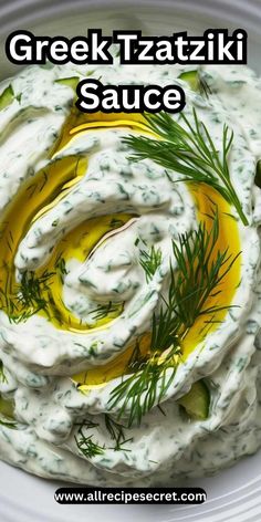 greek tzatziki sauce in a white bowl with dill sprigs