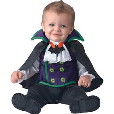 a baby dressed in a costume sitting on the ground