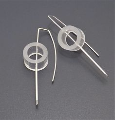 two metal objects on a gray surface with wires in the middle and one wire sticking out of it