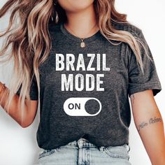 Brazil Mode T-Shirt, Love Brazil Shirt, Brazil Vacation, Brazil Family Trip, Honeymoon Shirt, Travel, Brazilian Shirt, Brazil Gift T-Shirt * Bella + Canvas 3001 Unisex T-shirt * 100% combed and ring-spun cotton (Heather colors contain polyester) * Pre-shrunk fabric * Feels soft and lightweight * Fits true to size HOW TO ORDER 1. Select your desired size, color and quantity from the drop-down menus. 2. Click "Add to Cart" and proceed to checkout. SIZING Please see the size chart image for specific measurements. NOTE ON TEXT/GRAPHICS COLORS For lighter-colored shirts, please note that any white graphics or text will print as black. You can see an example of this in our color chart, where black text indicates this change. RETURNS Due to the personalized nature of our made-to-order products, w Brazilian Shirt, Brazil Vacation, Brazil Shirt, Text Graphics, Honeymoon Shirts, Family Trip, Color Chart, Family Travel, Bella Canvas