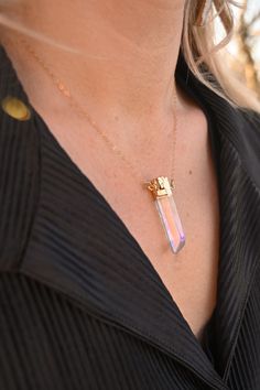 The magical Angel Aura Quartz in a point necklace! This beauty shines and glows without even trying. The rainbow aura is truly beautiful and will be an eye-catcher to all who see you. Angel Aura Quartz is the stone of good vibes. Like a rainbow in the sky, wear this timeless crystal necklace and repeat this mantra to yourself: I Am Limitless. Angel Aura Quartz crystal pendant with gold detailing 14k gold fill cable or satellite chain Handmade in Arizona Please use the size guide below to confirm