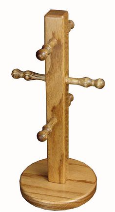 a wooden cross on a stand with two nails sticking out of it's sides