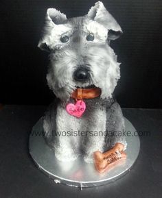 a cake shaped like a dog sitting on top of a plate with a bone in it's mouth