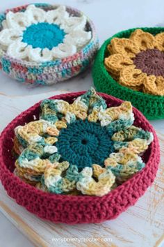 three crocheted bowls sitting on top of a table