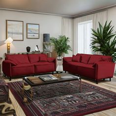 a living room with red couches and rugs