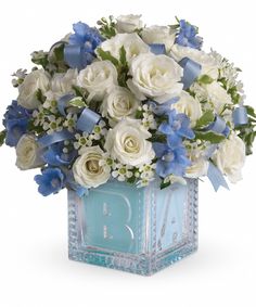 blue and white flowers in a square vase