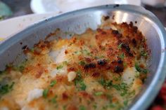 a silver pan filled with food on top of a table