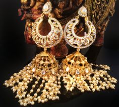 Large Jhumka Chandelier earrings    If traditional Jhumka Earrings is what you love then enjoy this new beauty that I just designed in my New Collection. These earrings are 4.5 inches long from top to tip  Made with a gold plated base the post is hypoallergenic. These are lightweight as compared to what they seem to be. red top and pearl strings There are 2 options in the earrings please pick your choice from the drop down 1) Pearl - Red stone top 2) Pearl - Pearl top A favorite in the fashion circuits. Enjoy this piece to your hearts content. Thank you for your appreciation. www.taneesi.com  Go back to Storefront Taneesijewelry.etsy.com  View my Entire CHANDELIER EARRING Collection at  https://www.etsy.com/shop/taneesijewelry?section_id=13293573 View my Entire HOOP EARRING Collection at Traditional Jhumka, Pearl Strings, Dome Earrings, Jewellery Board, Pearl Top, Head Wraps For Women, Pearl Chandelier, African Head Wraps, African Necklace