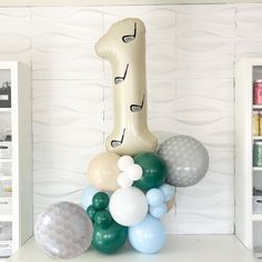 balloons are arranged in the shape of a giraffe on top of a shelf